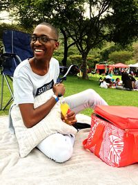 Portrait of smiling young woman sitting outdoors