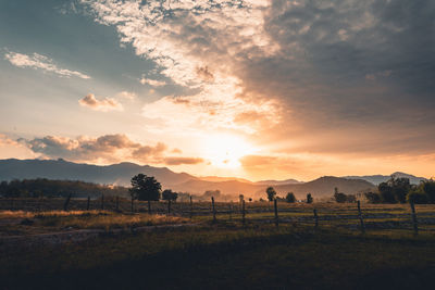 Scenic view of field against sky during sunset