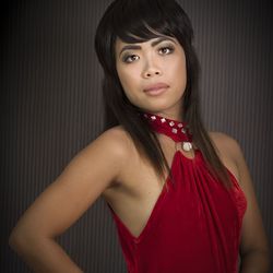 Portrait of young woman wearing red dress