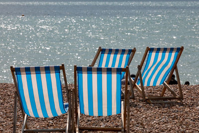 Chairs on beach against sea
