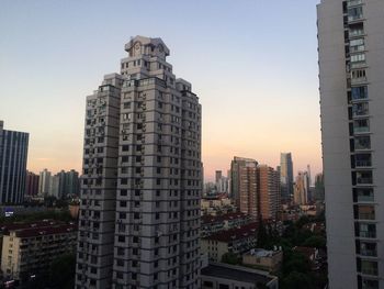 Skyscrapers in city at dusk