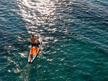 High angle view of men on boat in sea