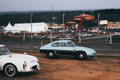 Car on road against buildings in city