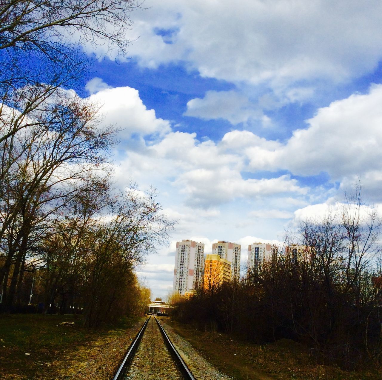 the way forward, transportation, diminishing perspective, sky, railroad track, tree, vanishing point, cloud - sky, rail transportation, built structure, architecture, building exterior, road, cloud, cloudy, day, outdoors, no people, long, bare tree