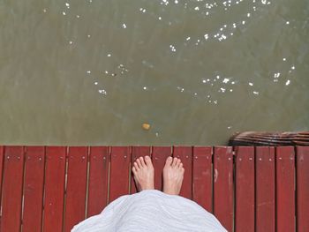 Low section of woman standing on pier