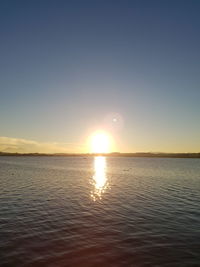 Scenic view of sea against clear sky during sunset