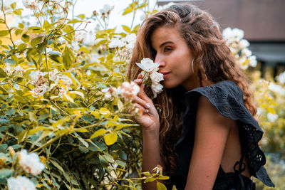 Beautiful woman with white flower on spring time.