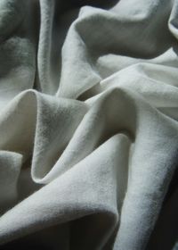 Close-up of crumpled blanket on bed