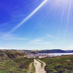 Footpath leading to calm blue sea