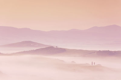 Sunrise with fog over a valley in tuscany - italy