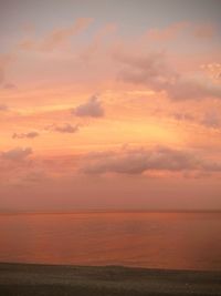 Scenic view of sea against orange sky