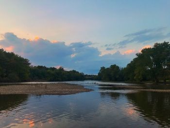 Scenic view of lake against sky at sunset