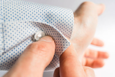 Cropped hands of man buttoning sleeve