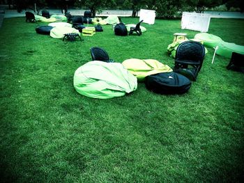 Empty chairs in grassy field