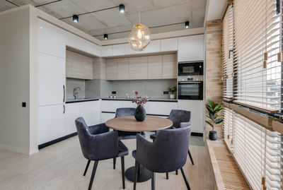 Kitchen and dining table near the window in a modern interior in loft style