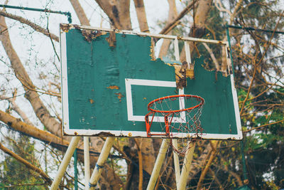 Close-up of rusty sign on fence