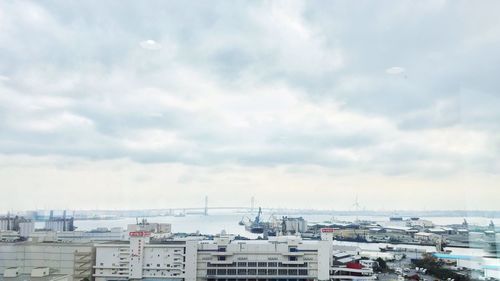 Harbor against cloudy sky