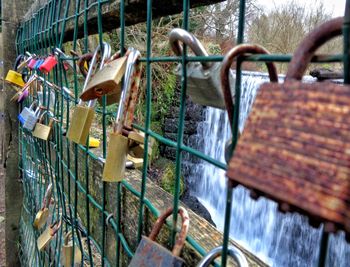 Close-up of padlocks hanging on railing