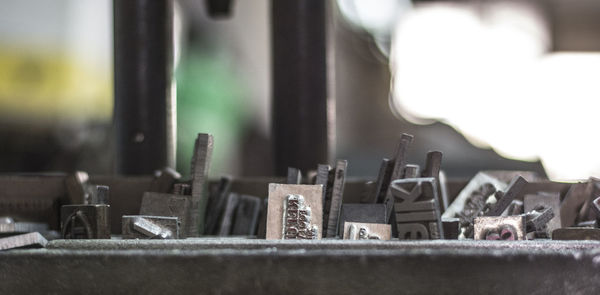 Close-up of pipes on table by window