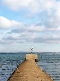 Pier over sea against sky