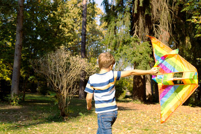 Boy playing with plants in park