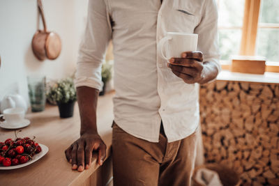 Midsection of man standing on table