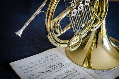 Close-up of trumpet on musical note