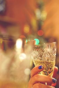 Close-up of hand holding illuminated christmas lights