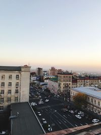 High angle view of road by buildings against sky during sunset