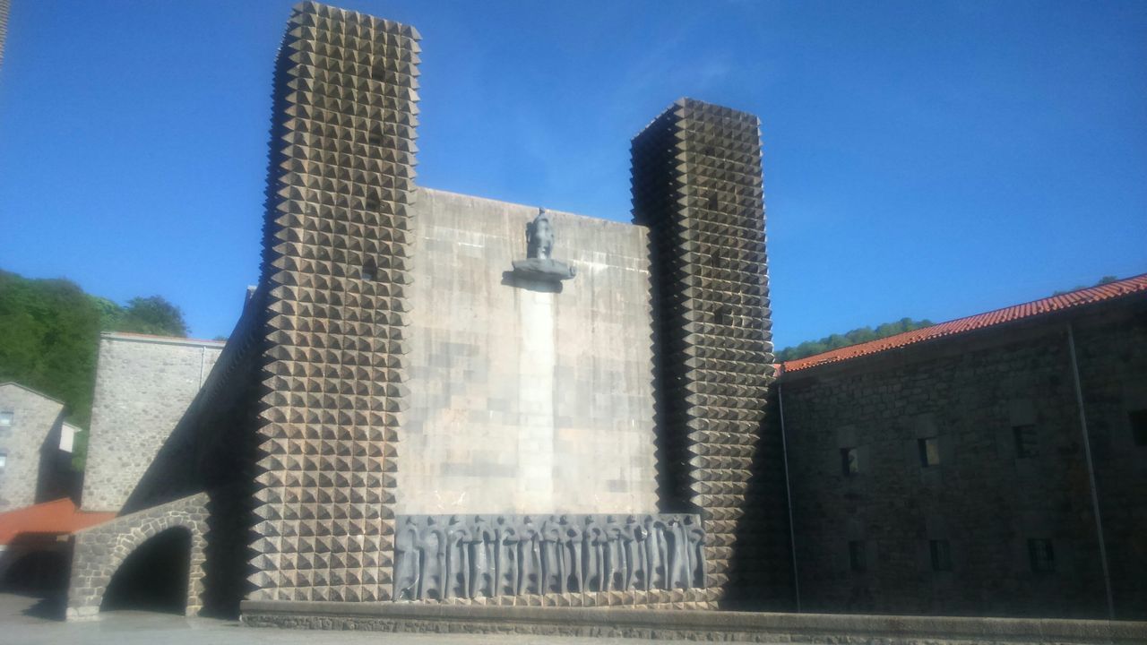 architecture, building exterior, built structure, clear sky, low angle view, blue, history, sunlight, building, city, day, outdoors, tower, old, famous place, exterior, no people, travel destinations, sky, wall - building feature