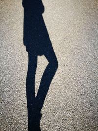 Low section of woman standing on tiled floor