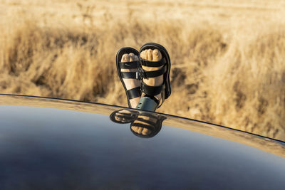 Man with prosthetic leg relaxing in car on sunny day