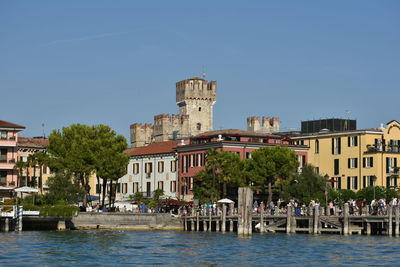 View of buildings against clear blue sky