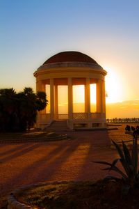 Silhouette of built structure at sunset