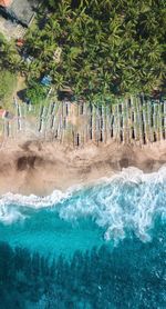 Aerial view of outriggers on sea shore at beach