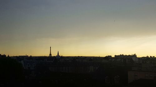 Silhouette cityscape against sky during sunset