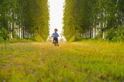 Full length of boy riding bicycle at park