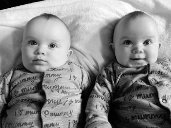 High angle view of twin baby boys relaxing on bed at home