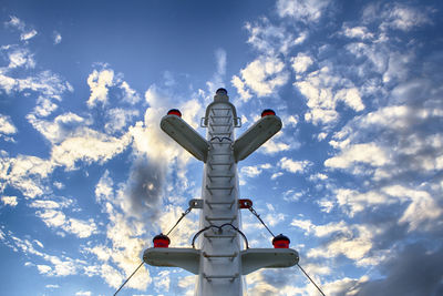 Low angle view of telephone pole against sky