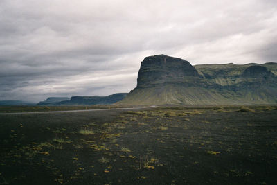 Scenic view of mountains against cloudy sky