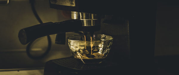 Coffee pouring from coffee machine at cafe