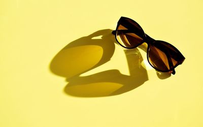 High angle view of sunglasses on glass