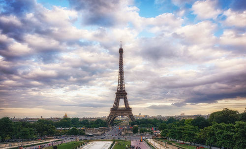 Eiffel tower against cloudy sky