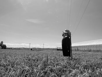 Woman on field against sky