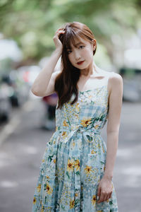 Portrait of young woman standing outdoors