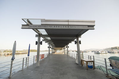 View of pier on beach against clear sky