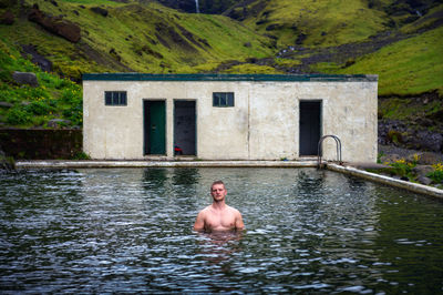 Rear view of man swimming in lake