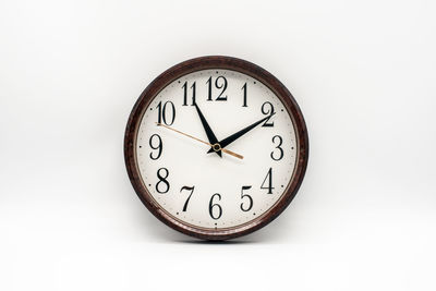 Close-up of clock on white background