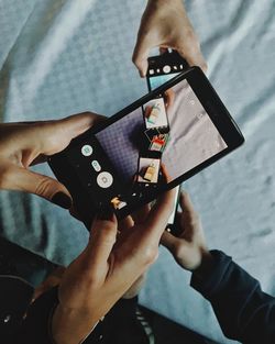 Cropped image of woman holding smart phone