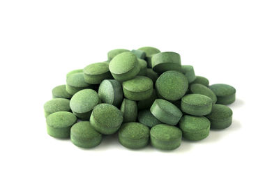 Close-up of green candies against white background